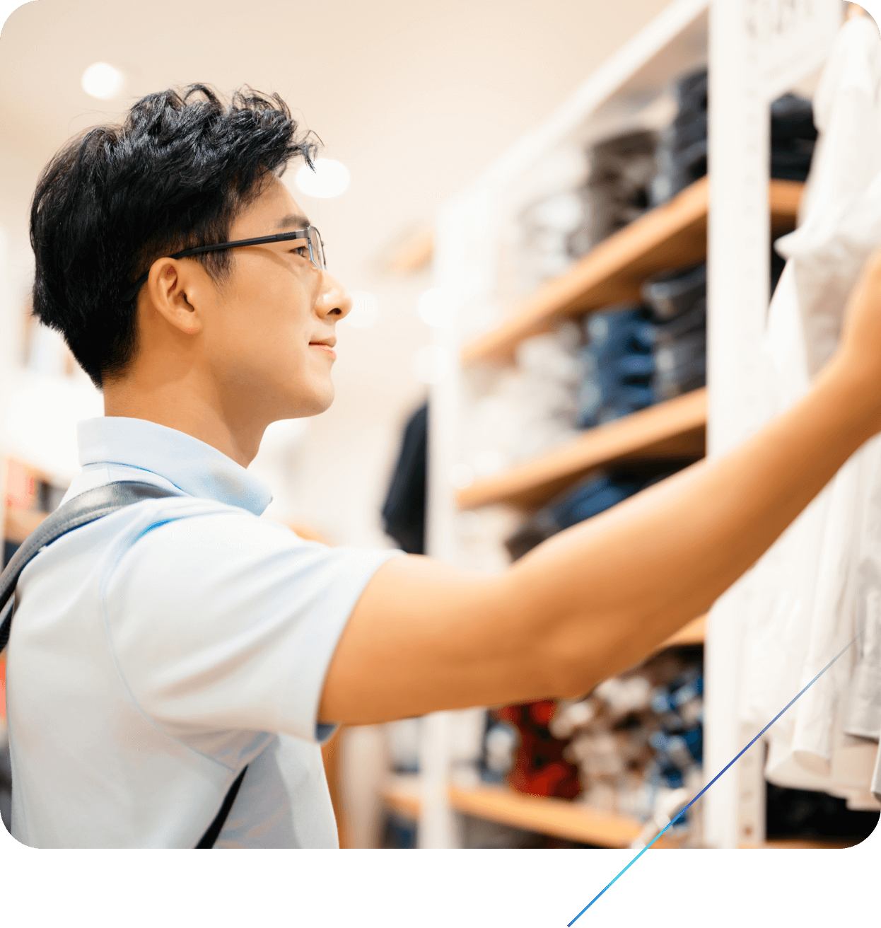 Person selecting apparel from a retail store shelf